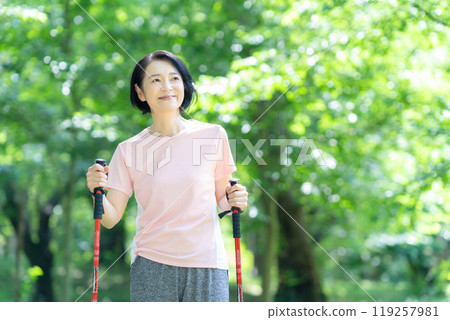 Middle-aged woman doing Nordic walking 119257981
