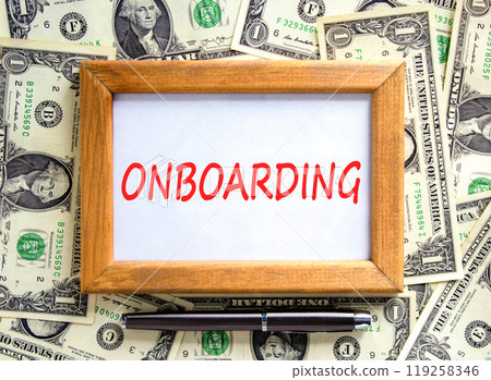 Onboarding success symbol. Concept word Onboarding on beautiful wooden picture frame. Beautiful dollar bills background. Dollar bills. Black pen. Business onboarding success concept. Copy space. Onboarding success symbol. Concept word Onboarding on beautiful wooden picture frame. Beautiful dollar bills background. Dollar bills. Black pen. Business onboarding success concept. Copy space. 119258346