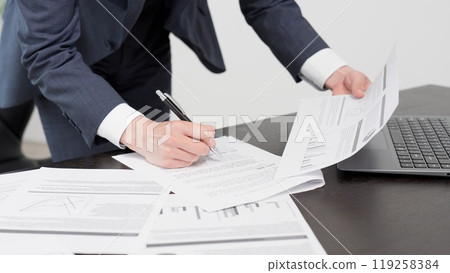 The hands of a businessman checking documents in a hurry The hands of a businessman checking documents in a hurry 119258384