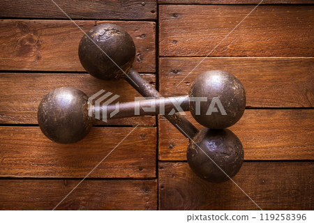 Old rusty dumbbells on wood background texture Old rusty dumbbells on wood background texture 119258396
