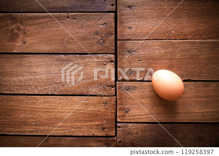 Egg on a rustic wooden board 119258397