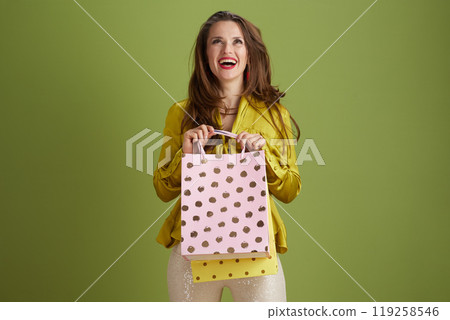 happy modern woman looking up against green background happy modern woman looking up against green background 119258546