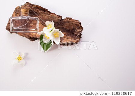 Jasmine flowers, bark and perfume bottle on white background. Flat lay. Copy space Jasmine flowers, bark and perfume bottle on white background. Flat lay. Copy space 119258617