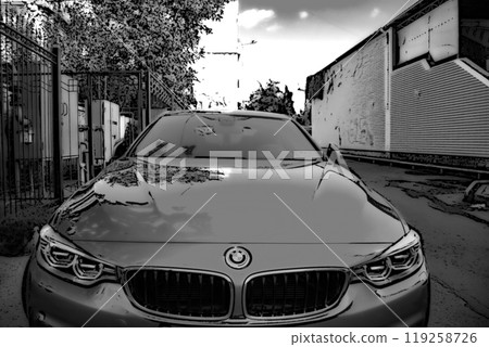 Beautiful car BMW 4 series. Indicative. On a sunny day, a car with folded mirrors is parked along the fence on the street. 119258726