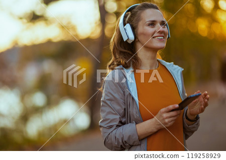 happy woman in fitness clothes in park happy woman in fitness clothes in park 119258929