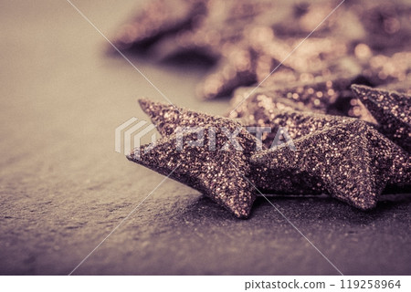 Group of dark luxury beautiful christmas stars decoration. Wonderful glamorous xmas star advent deco with illuminated sparkling glow. Traditional symbol scene with magical x-mas mood feelings. 119258964