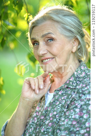 Portrait of a beautiful woman in the park in summer Portrait of a beautiful woman in the park in summer 119259117