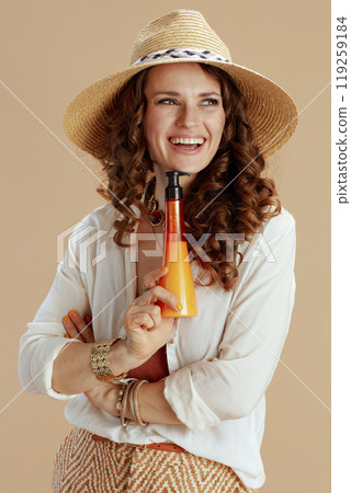 happy elegant woman in blouse and shorts on beige 119259184