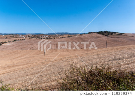A photo of the San Quirico hills captures the essence of the stunning Tuscan landscape A photo of the San Quirico hills captures the essence of the stunning Tuscan landscape 119259374