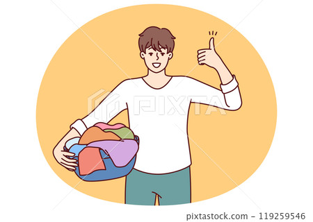 Man householder with laundry in basin shows thumbs up recommending quality laundry detergent 119259546