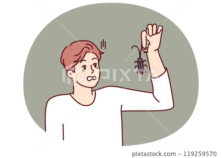 Man with bug in hand, looks at insect and gets scared suffering from arachnophobia and disgust 119259570