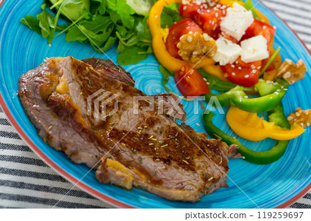 Roasted veal steak with salad 119259697