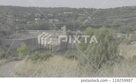 Hydroelectric Power Station in a Deep Canyon with Swaying Trees 119259987