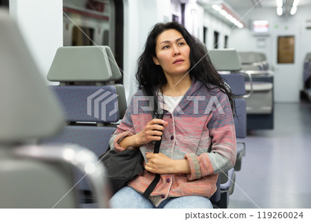 Portrait of asian woman traveler with backpack and suitcase in subway car 119260024