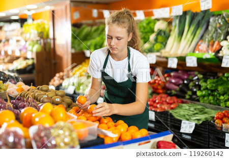 Girl at her first job in vegetable shop Girl at her first job in vegetable shop 119260142