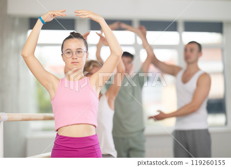 Girls and boys of choreographic lesson learn from experienced master of theatrical studio Girls and boys of choreographic lesson learn from experienced master of theatrical studio 119260155
