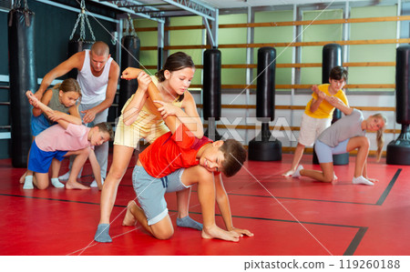 Kids in pair exercising self-defense movements Kids in pair exercising self-defense movements 119260188