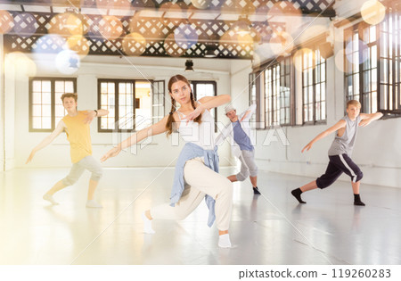 Group of young artists performing street dance Group of young artists performing street dance 119260283