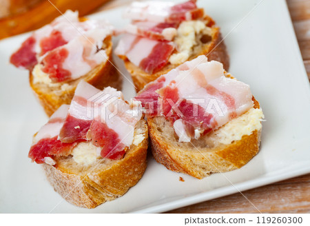 Traditional Russian and Ukrainian food, salted smoked pork bacon with horseradish on wooden background Traditional Russian and Ukrainian food, salted smoked pork bacon with horseradish on wooden background 119260300