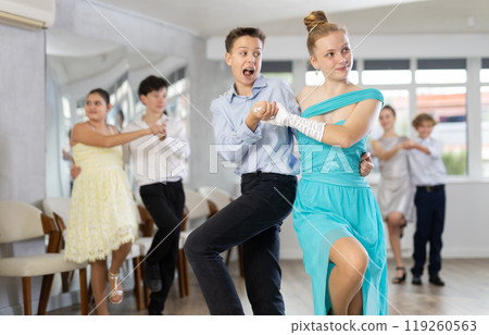 Teen boy and girl are dancing contemporary modern discofox in couple during lesson at studio Teen boy and girl are dancing contemporary modern discofox in couple during lesson at studio 119260563