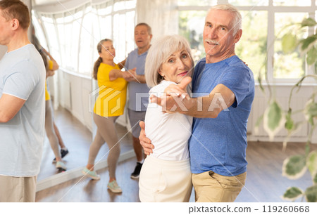 Aged woman and man learning to dance Viennese waltz in dancing class 119260668