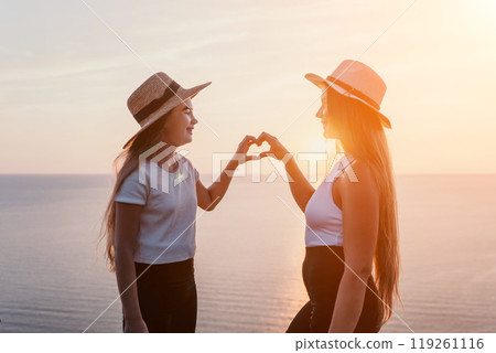 Mother and Daughter Making a Heart Shape at Sunset Mother and Daughter Making a Heart Shape at Sunset 119261116