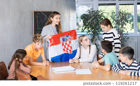 Teacher showing Croatia flag to group of schoolchildren Teacher showing Croatia flag to group of schoolchildren 119261217
