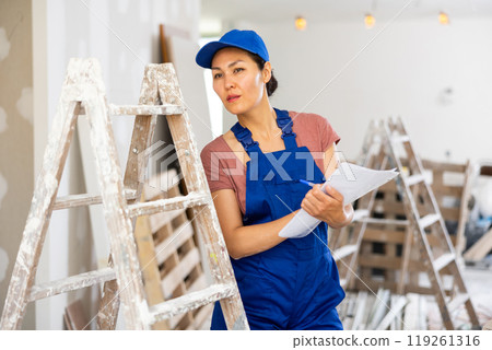 Woman builder checking project documentation Woman builder checking project documentation 119261316