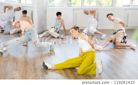 Teenage girl practicing hip-hop floor-works in training hall 119261433