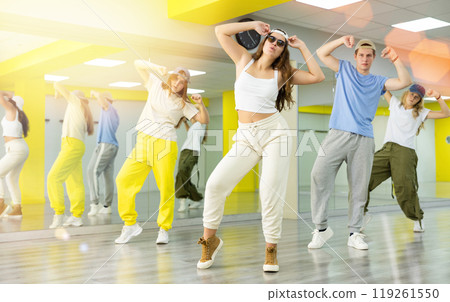 Portrait of teens dancer in choreographic studio with dancing teenagers in background 119261550