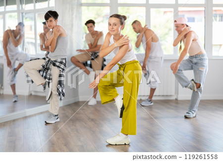 Teenage girl dancing hip hop in group 119261558