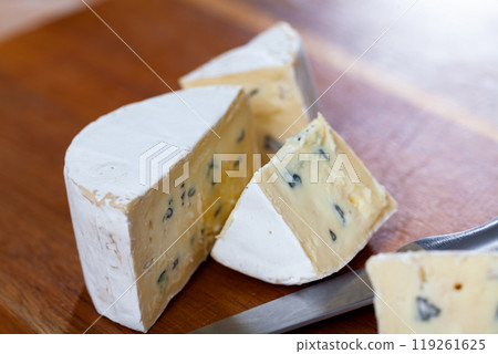 Slices of soft blue cheese on cutting board Slices of soft blue cheese on cutting board 119261625