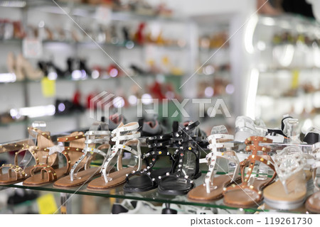Womens sandals of latest summer collection are presented on glass window of store 119261730
