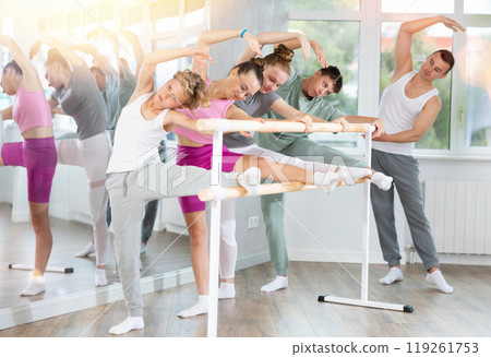 Ballet pose grand batman - girls and boys at a choreography lesson are learning ballet movements in studio 119261753