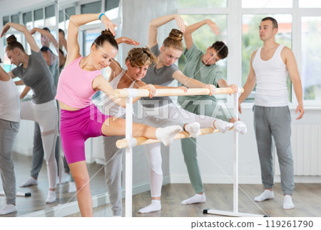 Ballet pose grand batman - girls and boys at a choreography lesson are learning ballet movements in studio 119261790