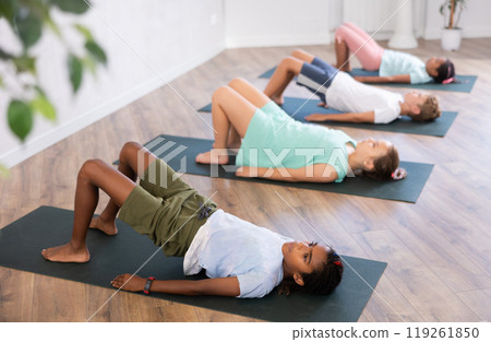 Kids yoga exercise - setu bandha sarvangasana. Kids yoga exercise - setu bandha sarvangasana. 119261850