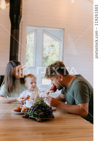 Father and son enjoying breakfast together with fresh fruit and pastries, creating family moment Father and son enjoying breakfast together with fresh fruit and pastries, creating family moment 119261883