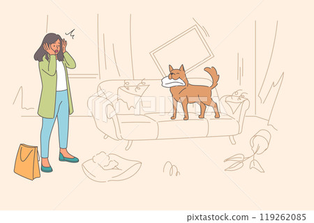 Unmannered dog that has robbed apartment stands on torn sofa near disappointed woman guardian 119262085