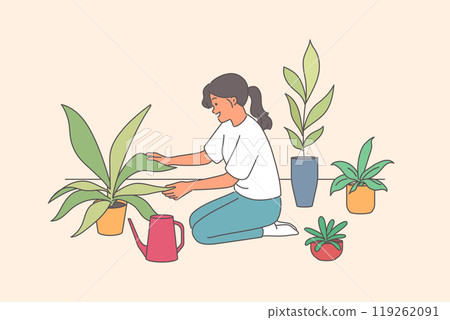 Woman florist takes care of house plants and carefully holds on to petals kneeling near watering can 119262091