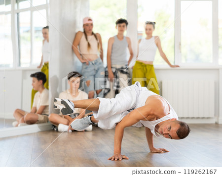 Dance teacher shows how to dance low breaking in studio 119262167