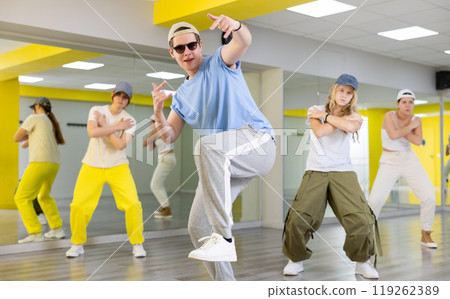 Portrait of teenager boy performing hip hop at dance class Portrait of teenager boy performing hip hop at dance class 119262389
