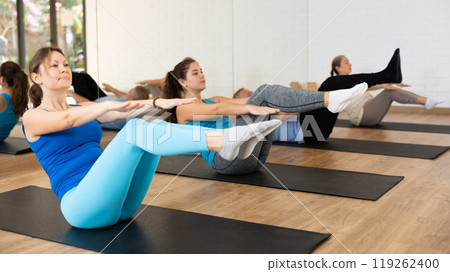 Young woman doing v-sit during warming up in pilates studio 119262400