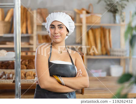 Young female seller posing in bakery Young female seller posing in bakery 119262432