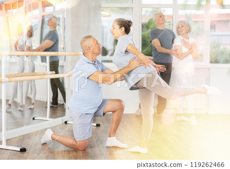 Elderly couples learning to dance ballet in dance studio Elderly couples learning to dance ballet in dance studio 119262466