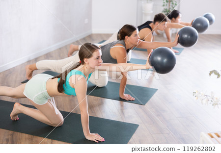 Girl participates in group lesson with sof tball, modern sport in studio. 119262802