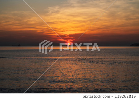 Amazing landscape with orange sunrise in morning at sea in summer Amazing landscape with orange sunrise in morning at sea in summer 119262819