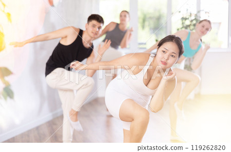 Asian girl perform choreographic exercise and teach energetic mobile social dance groove with friend 119262820