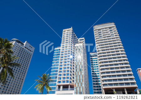 White facades of skyscraper hotels against the blue sky in summer in resort town in Asia White facades of skyscraper hotels against the blue sky in summer in resort town in Asia 119262821