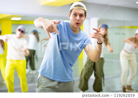 Teenage boy training breakdance Toprock moves in dance hall 119262859