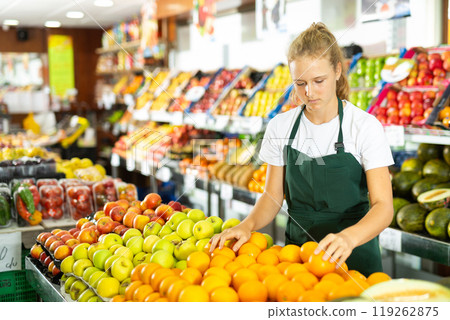 Girl at her first job in vegetable shop 119262875